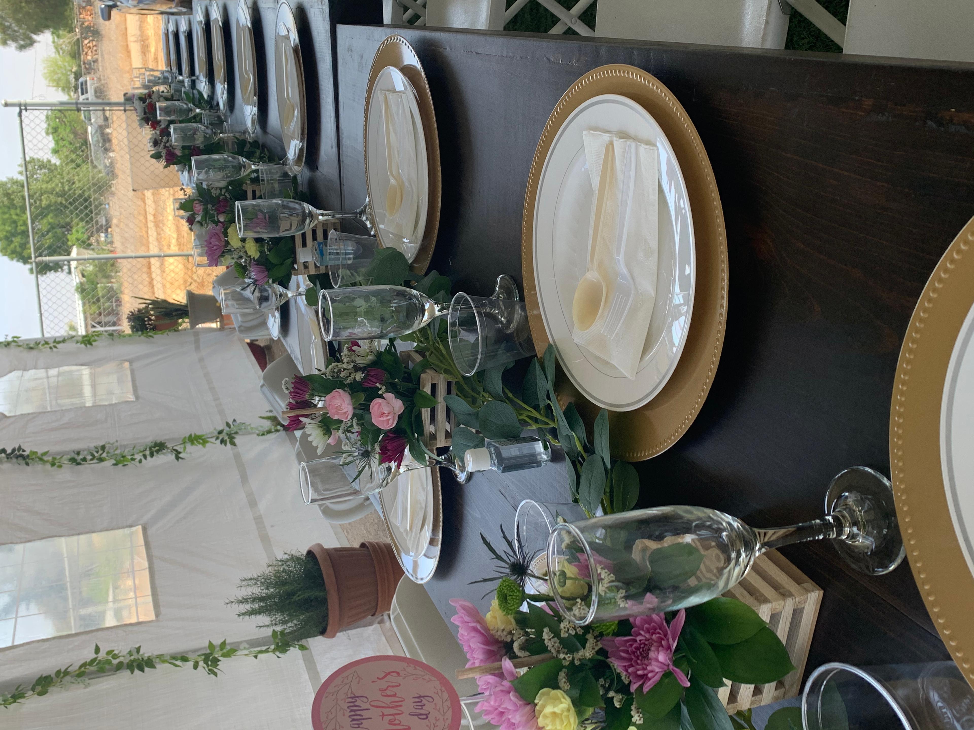 Long table with plates, glasses, and centerpieces