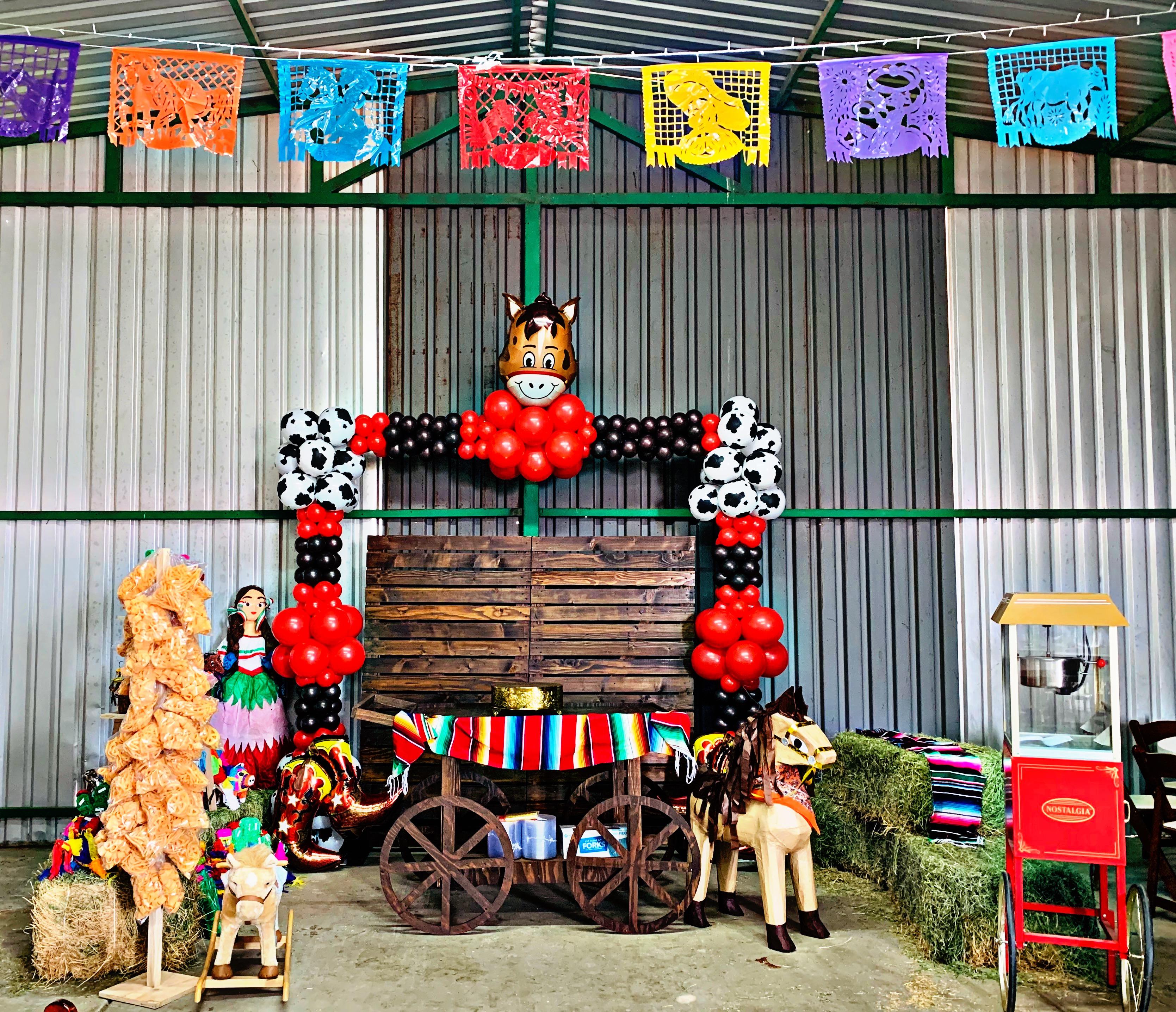 Farm ranch themed table display with horse decorations and balloons